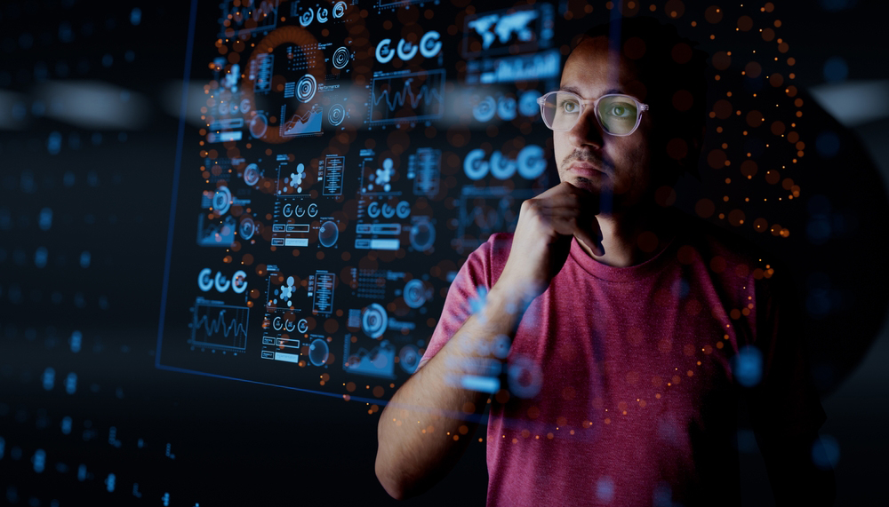 Person thinking looking at screen with data and information in front of him.