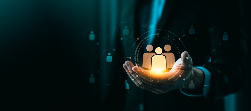 Hand holding a picture of three people connected to other hovering pictures.