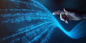 Person holding finger Infront of screen with digits and numbers